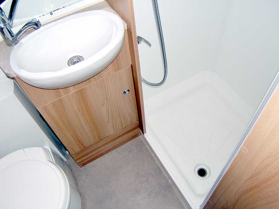 The towel rail, washbasin and shower cubicle.